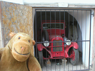 Mr Monkey examining a Chevrolet car turned into a fire engine