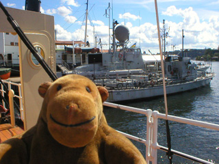 Mr Monkey looking at naval vessel next to the lightship