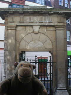 Mr Monkey in front of a gate at St Giles