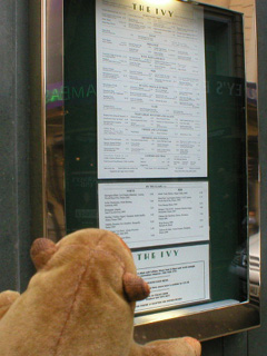 Mr Monkey examining the menu aoutside The Ivy
