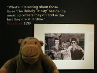 Mr Monkey with a picture of David Bowie, iggy Pop and Lou Reed