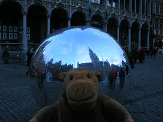 Mr Monkey looking at an inflatible silver globe