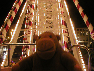 Mr Monkey looking at the spokes of the Ferris Wheel