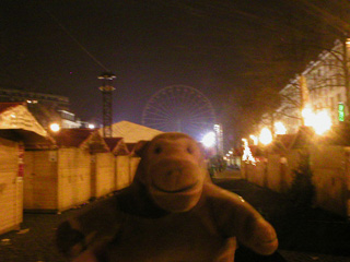 Mr Monkey walking through a closed Christmas market