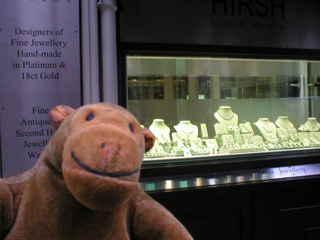 Mr Monkey looking at a jewellers shop window