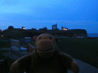 Mr Monkey looking at Tynemouth Priory in the dark
