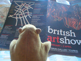 Mr Monkey looking the British Art Show 6 brochure