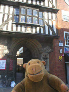 Mr Monkey in front of the gatehouse of the church