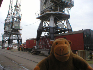 Mr Monkey looking at mobile cranes outside the museum