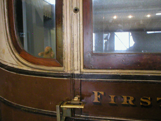 Mr Monkey looking out of a first class railway carriage