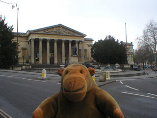 Mr Monkey looking at the Victoria Rooms of Bristol University