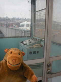 Mr Monkey looking into a bridge control booth