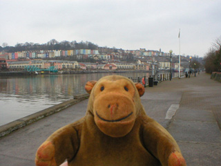 Mr Monkey walking along a quay at the 