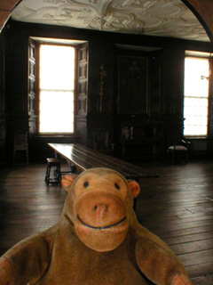 Mr Monkey looking through a doorway into the great oak room