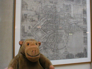 Mr Monkey in front of a map of 17th century Bristol