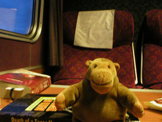 Mr Monkey travelling in a older railway carriage