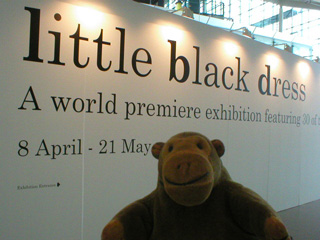 Mr Monkey in front of the signage for Little Black Dress