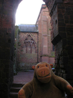 Mr Monkey looking at arches in the ruined end of Saint John's