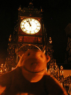 Mr Monkey in front of a large clock
