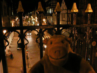 Mr Monkey looking down on Eastgate street from the wall