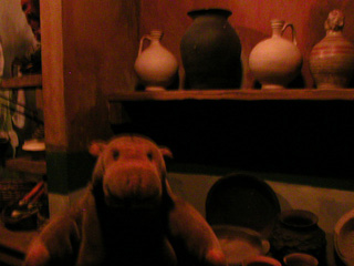 Mr Monkey examining a pottery shop