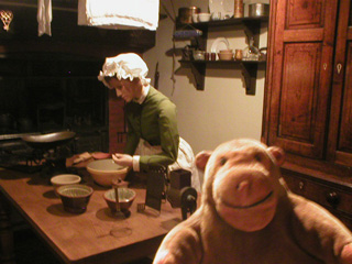 Mr Monkey looking at a recreated Victorian kitchen