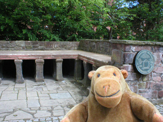 Mr Monkey in front of a reconstructed Roman hypocaust