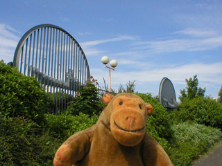 Mr Monkey examining railings with ships on