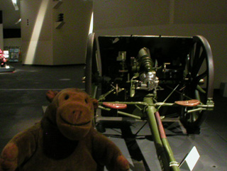 Mr Monkey looking at a British 13-pounder field gun