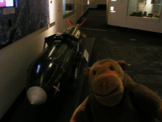 Mr Monkey examining a dummy atomic bomb in Silo 5