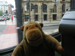 Mr Monkey on a tram in the centre of Manchester
