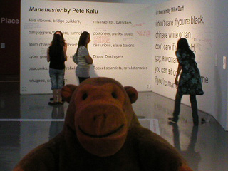 Mr Monkey looking at a pair of Manchester poems