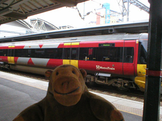 Mr Monkey looking at a train at Leeds station