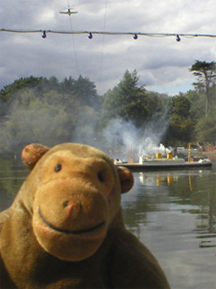 Mr Monkey watching a model plane fly over the sea battle