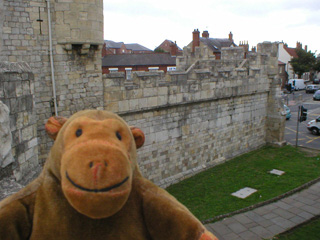 Mr Monkey looking at Walmgate Bar from the wall