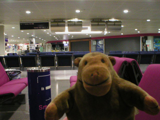 Mr Monkey in an empty departure lounge