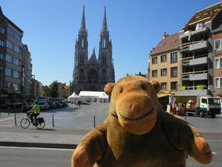 Mr Monkey looking across the square at the St Peter and Paul church