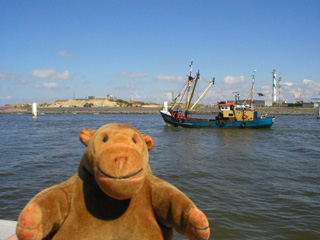 Mr Monkey watching a trawler leave Ostende harbour