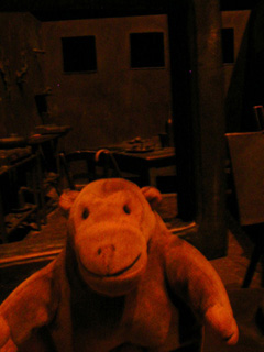 Mr Monkey looking into the window of a strange sloping room
