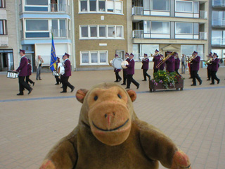 Mr Monkey looking at a brass band