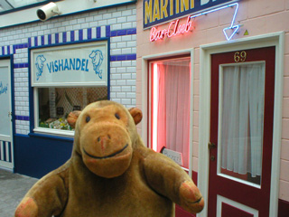 Mr Monkey looking at recreated shop fronts at the stern of the Amandine