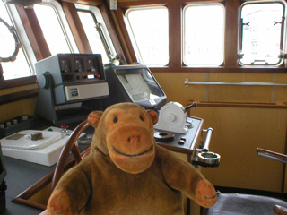 Mr Monkey examining the navigation equipment on the bridge
