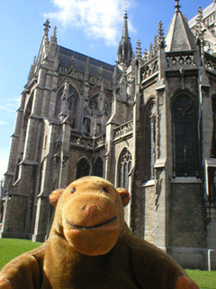 Mr Monkey looking at the side of St Peter and Paul church