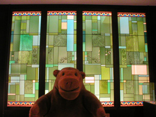 Mr Monkey with a stained glass panel by Constant Montald