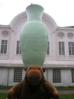 Mr Monkey in front of a giant green vase