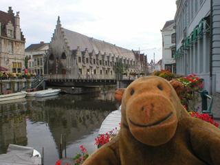 Mr Monkey looking along a canal to the Vleeshuis