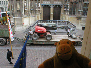 Mr Monkey watching a cherry-picker being put onto a low-loader