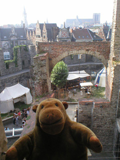 Mr Monkey looking down through an arch at the courtyard