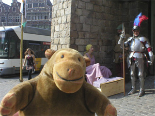 Mr Monkey looking at an armoured knight at the gateway of the Castle of the Counts