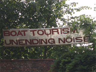 A complaining sign 'Boat tourism unending noise' put up by a local resident